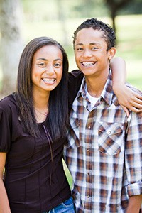 Teen Girl and Boy wiht Braces Smiling